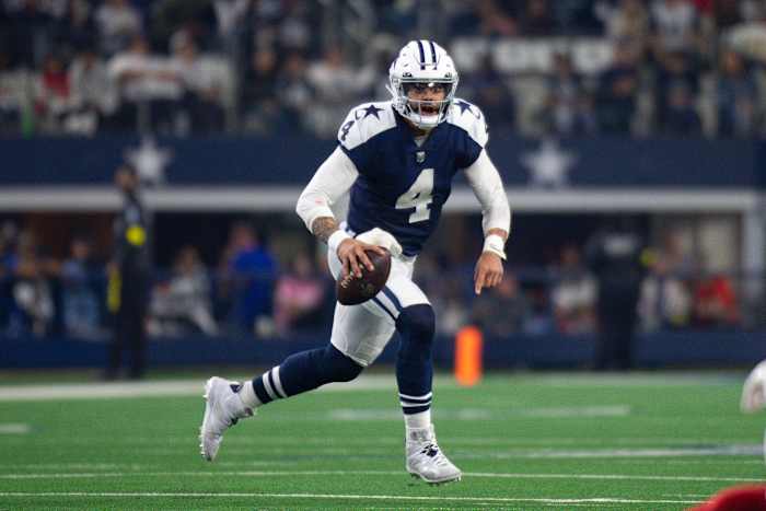 Dallas Cowboys quarterback Dak Prescott runs with the football.
