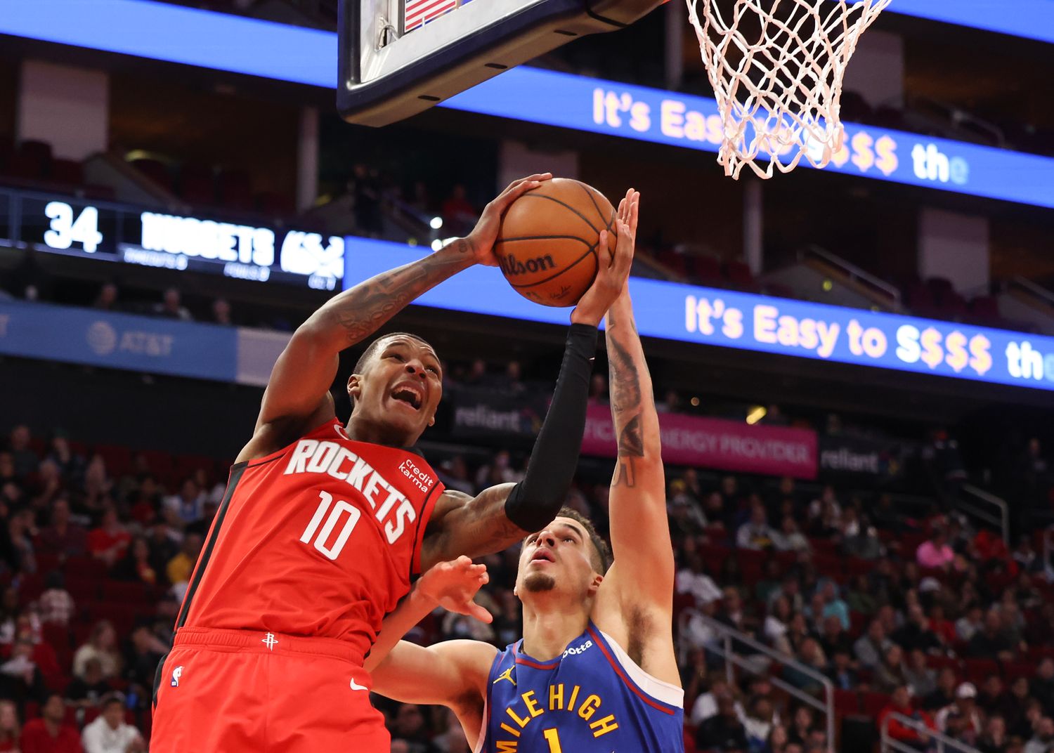 Rockets forward Jabari Smith Jr. scores against Denver Nuggets forward Michael Porter Jr. (1) in the second quarter at Toyota Center.