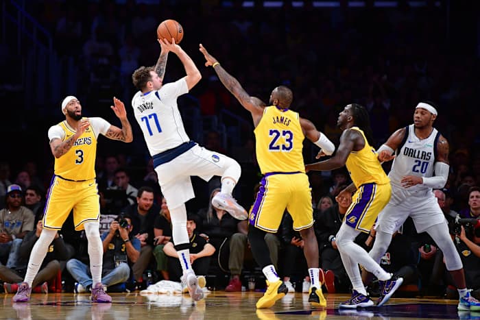 Dallas Mavericks star Luka Doncic shoots a Dirk Nowitzki-esque one-legged fadeaway over Los Angeles Lakers' LeBron James.