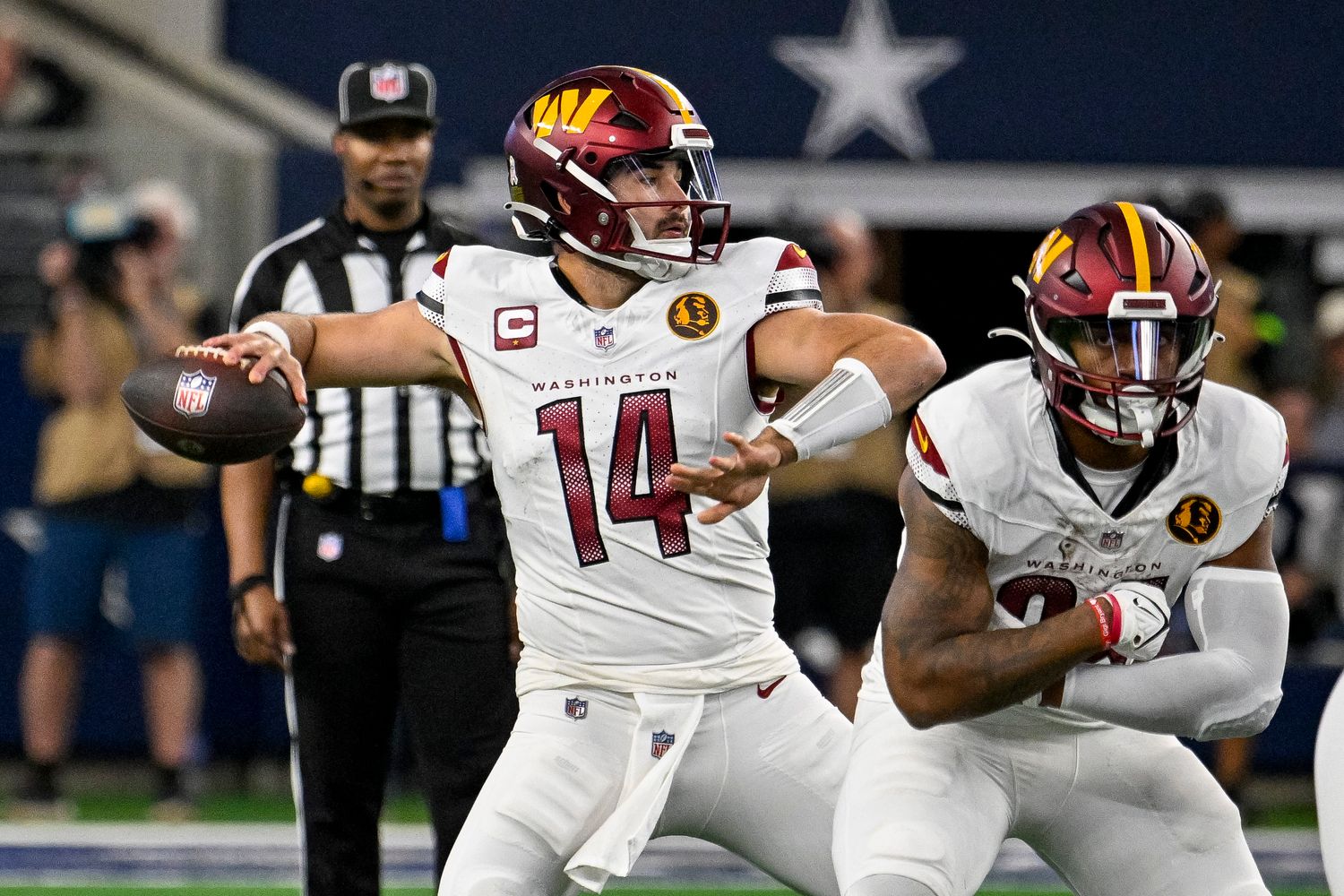 Washington Commanders quarterback Sam Howell (14) passes against the Dallas Cowboys during the first quarter at AT&T Stadium.