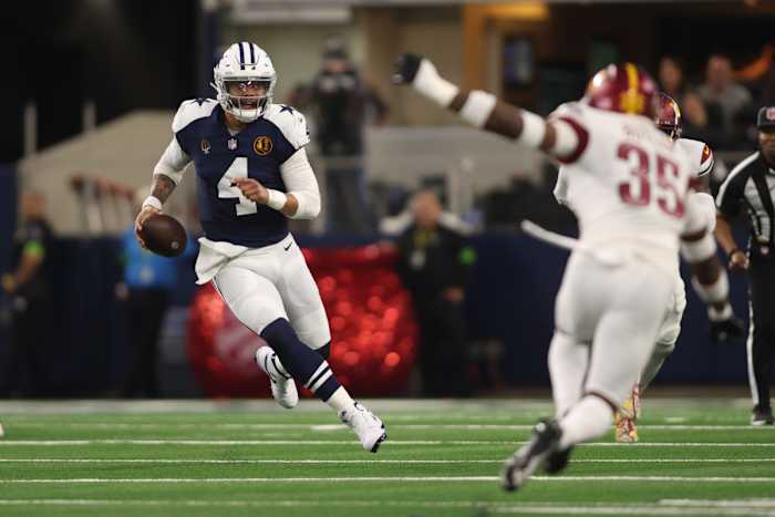 Dak Prescott runs with the ball