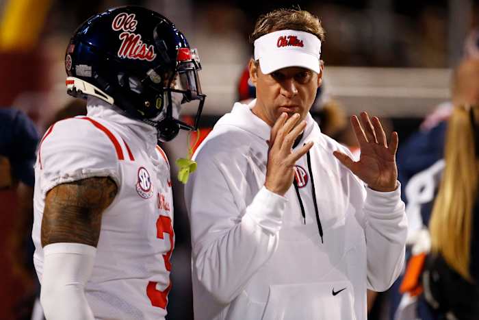 Nov 23, 2023; Starkville, Mississippi, USA; Mississippi Rebels head coach Lane Kiffin (right) talks with defensive back Daijahn Anthony (3) prior to the game against the Mississippi State Bulldogs at Davis Wade Stadium at Scott Field. Mandatory Credit: Petre Thomas-USA TODAY Sports