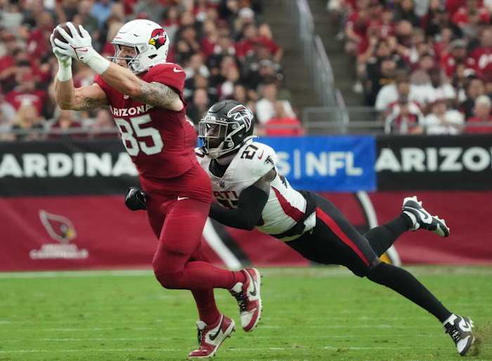 Arizona Cardinals tight end Trey McBride (85) catches a pass over Atlanta Falcons safety Richie Grant (27) at State Farm Stadium.
