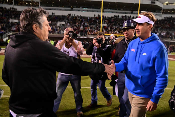 Nov 25, 2021; Starkville, Mississippi, USA; Mississippi State Bulldogs head coach Mike Leach and Mississippi Rebels head coach Lane Kiffin shake hands after the game at Davis Wade Stadium at Scott Field. Mandatory Credit: Matt Bush-USA TODAY Sports