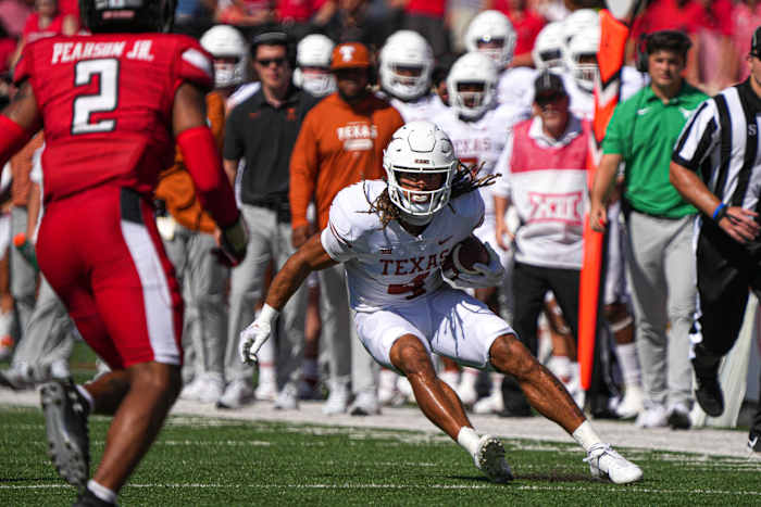 Texas Longhorns wide receiver Jordan Whittington (4) runs the ball against the Texas Tech Red Raiders at Jones AT&T Stadium.