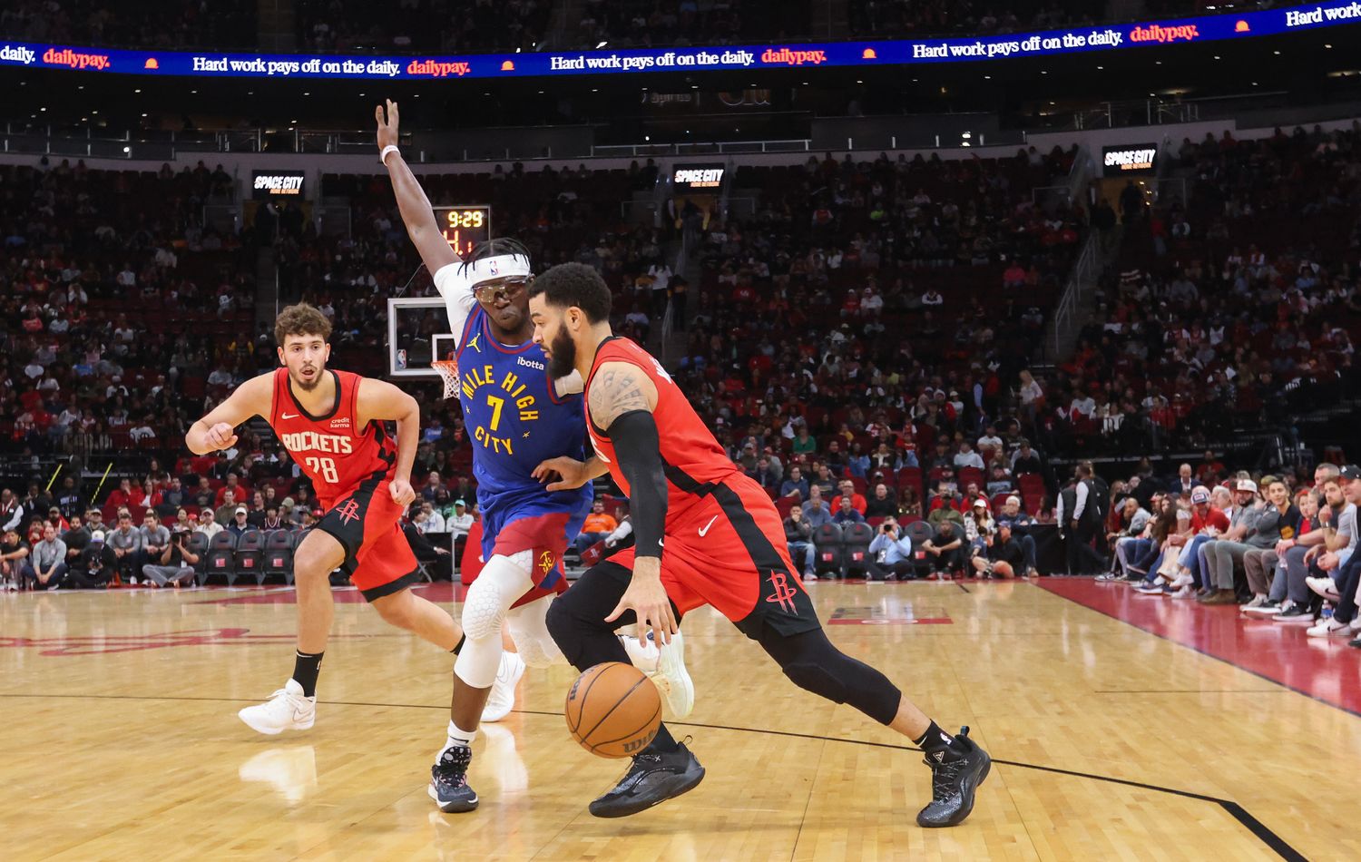 Rockets guard Fred VanVleet dribbles against Denver Nuggets guard Reggie Jackson (7) in the first quarter at Toyota Center.