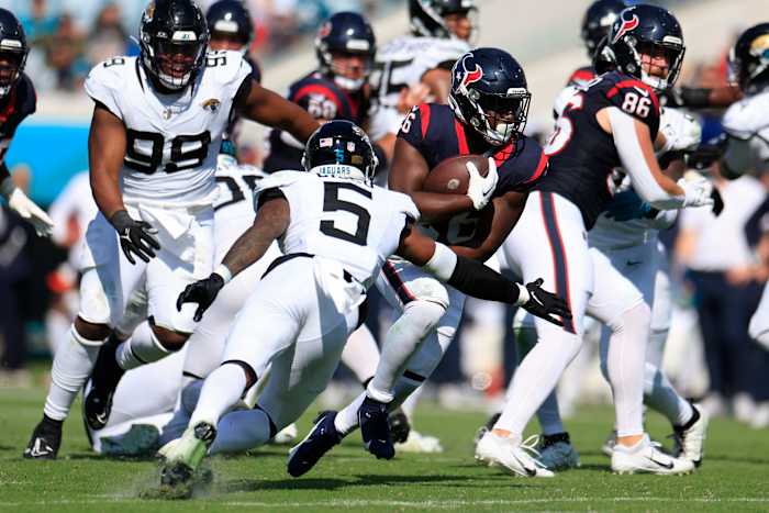 Singletary rushes for yards against Jacksonville Jaguars safety Andre Cisco during the fourth quarter at EverBank Stadium in Jacksonville.