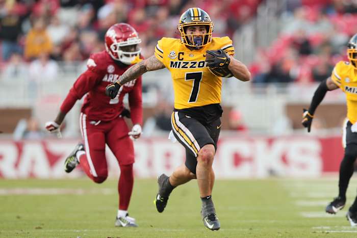 Nov 24, 2023; Fayetteville, Arkansas, USA; Missouri Tigers running back Cody Schrader (7) rushes against the Arkansas Razorbacks during the second quarter at Donald W. Reynolds Razorback Stadium. Mandatory Credit: Nelson Chenault-USA TODAY Sports