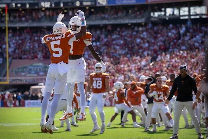 Oct 7, 2023; Dallas, Texas, USA; Texas Longhorns defensive back Malik Muhammad (5) and wide receiver Xavier Worthy (1) celebrate a touchdown against the Oklahoma Sooners during the first half at the Cotton Bowl. Mandatory Credit: Jerome Miron-USA TODAY Sports 