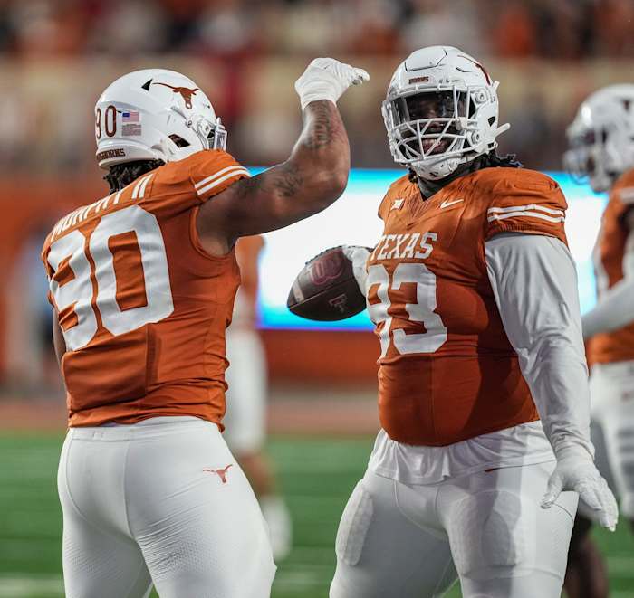 Texas Longhorns DT Byron Murphy celebrates with T'Vondre Sweat