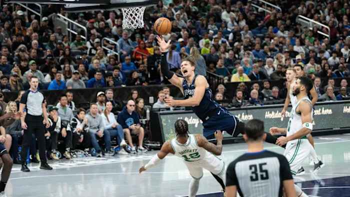 Orlando Magic center Moritz Wagner puts up a shot over Boston Celtics forward Oshae Brissett (12)