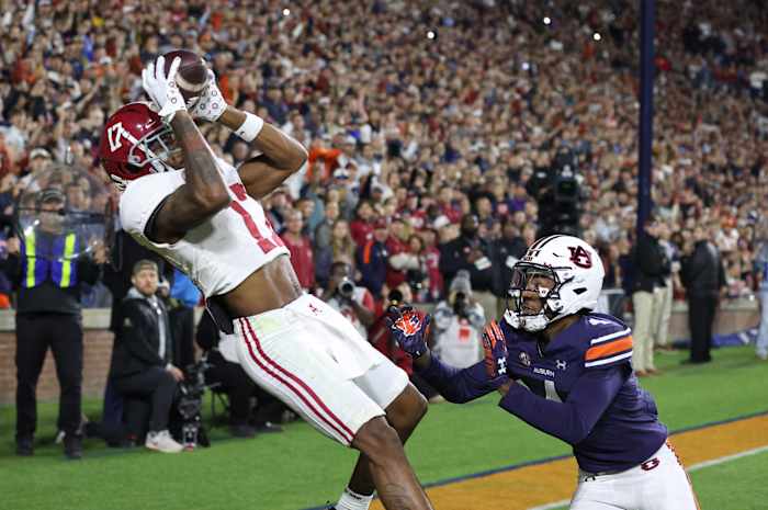 Nov 25, 2023; Auburn, Alabama, USA; Alabama Crimson Tide wide receiver Isaiah Bond (17) scores the game winning touchdown over Auburn Tigers cornerback D.J. James (4) during the fourth quarter at Jordan-Hare Stadium.