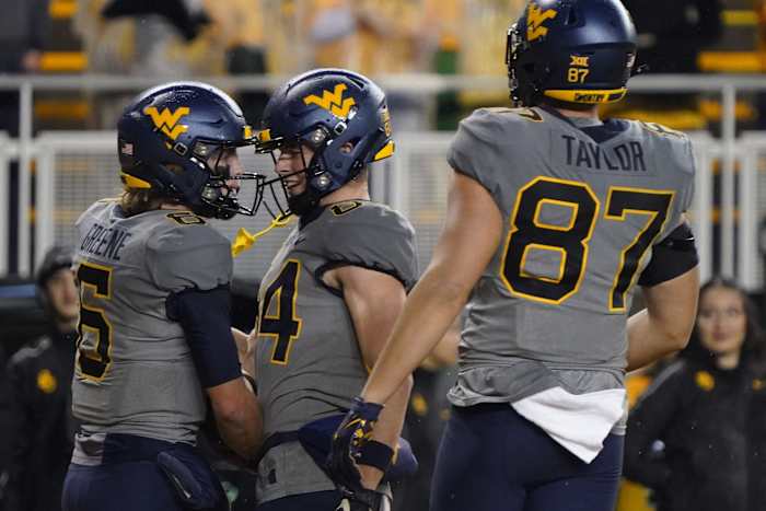 Nov 25, 2023; Waco, Texas, USA; West Virginia Mountaineers quarterback Garrett Greene (6) reacts with wide receiver Hudson Clement (84) after carrying the ball for a 23-yard touchdown against the Baylor Bears during the first half at McLane Stadium.