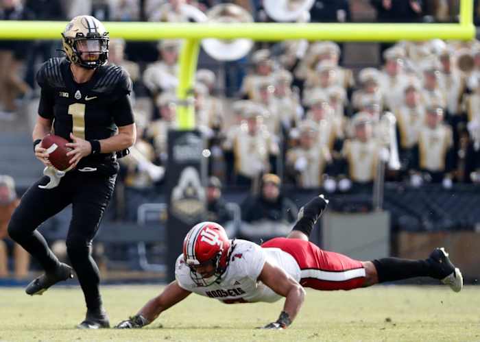 Purdue Boilermakers quarterback Hudson Card (1) breaks the tackle of Indiana Hoosiers linebacker Jacob Mangum-Farrar (7) on Saturday, Nov. 25, 2023 at Ross-Ade Stadium in West Lafayette, Ind. Purdue won 35-31.