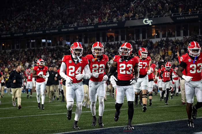 Georgia Bulldogs secondary trio of (#24) Malaki Starks, (#22) Javon Bullard, and (#23) Tykee Smith trotting off the field for halftime against Georgia Tech on Nov. 25, 2023. (Brooks Austin / Dawgs Daily).