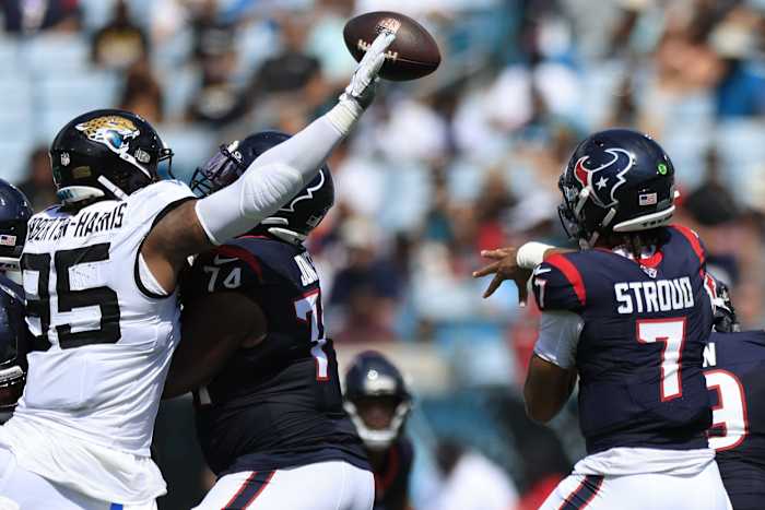 Texans' C.J. Stroud (7) is pressured by Jacksonville Jaguars defensive end Roy Robertson-Harris