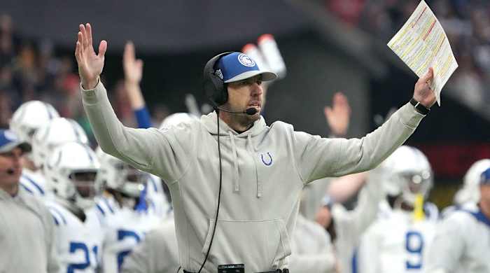 Colts coach Shane Steichen lifts his arms to signal touchdown on the sideline