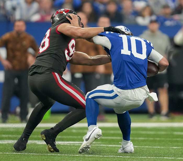 Tampa Bay Buccaneers linebacker Anthony Nelson (98) works to bring down Indianapolis Colts quarterback Gardner Minshew II (10) on Sunday, Nov. 26, 2023, during a game against the Tampa Bay Buccaneers at Lucas Oil Stadium in Indianapolis.
