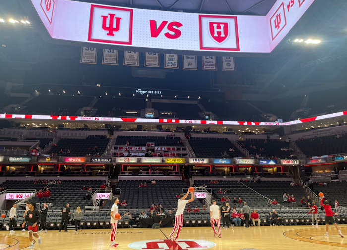 Trey Galloway, Anthony Leal and Gabe Cupps attempt half-court shots before Indiana's game against Harvard.