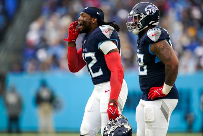 Tennessee Titans running back Derrick Henry (22) and defensive tackle Jeffery Simmons (98) on the sidelines during the second quarter against the Carolina Panthers.