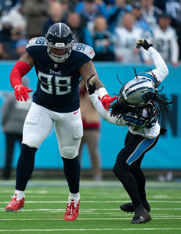 Tennessee Titans defensive tackle Jeffery Simmons (98) lays a block on Carolina Panthers cornerback Donte Jackson (26) during their game at Nissan Stadium.