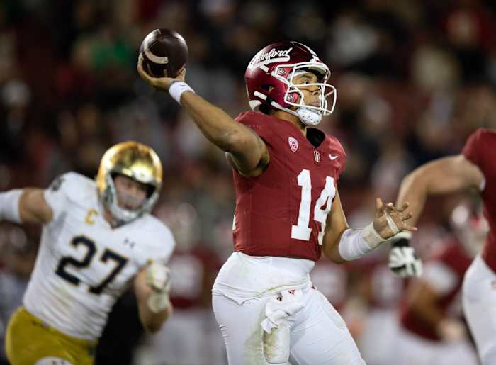 Nov 25, 2023; Stanford, California, USA; Stanford Cardinal quarterback Ashton Daniels (14) throws on the run while being pursued by Notre Dame Fighting Irish linebacker JD Bertrand (27) during the third quarter at Stanford Stadium. Mandatory Credit: D. Ross Cameron-USA TODAY Sports 
