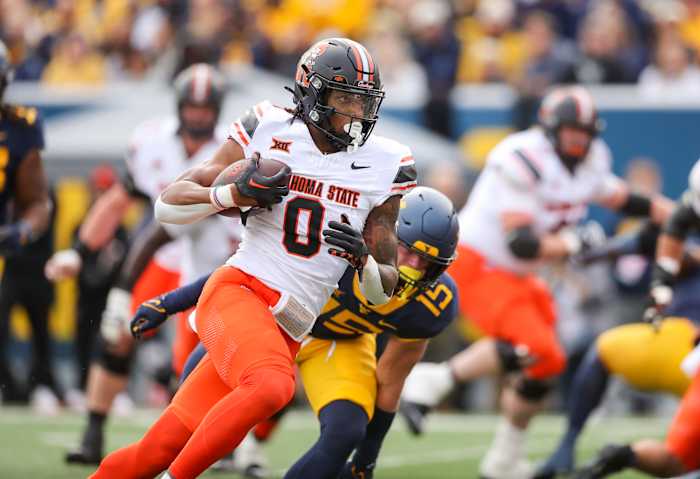 Oct 21, 2023; Morgantown, West Virginia, USA; Oklahoma State Cowboys running back Ollie Gordon II (0) runs for a touchdown during the first quarter against the West Virginia Mountaineers at Mountaineer Field at Milan Puskar Stadium. Mandatory Credit: Ben Queen-USA TODAY Sports