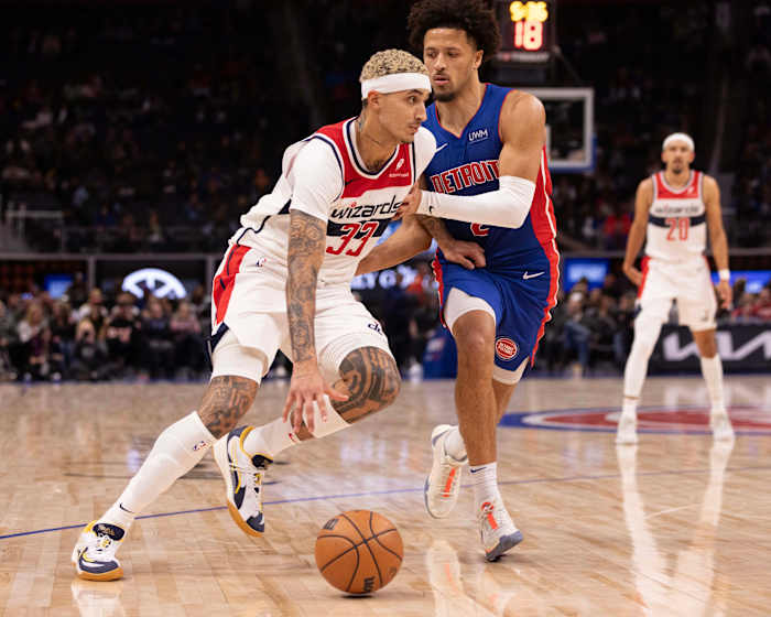 Washington Wizards forward Kyle Kuzma (33) drives to the basket next to Detroit Pistons guard Cade Cunningham (2) during the second half at Little Caesars Arena.
