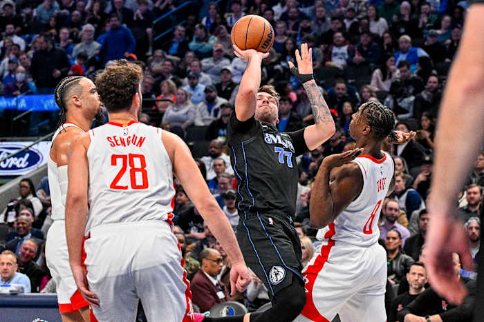 Dallas Mavericks star Luka Doncic draws the defensive attention of three Houston Rockets defenders.