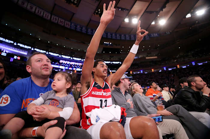 Washington Wizards guard Jordan Poole (13) reacts to a teammate's three point shot as he sits court side with fans during the third quarter against the New York Knicks at Madison Square Garden.