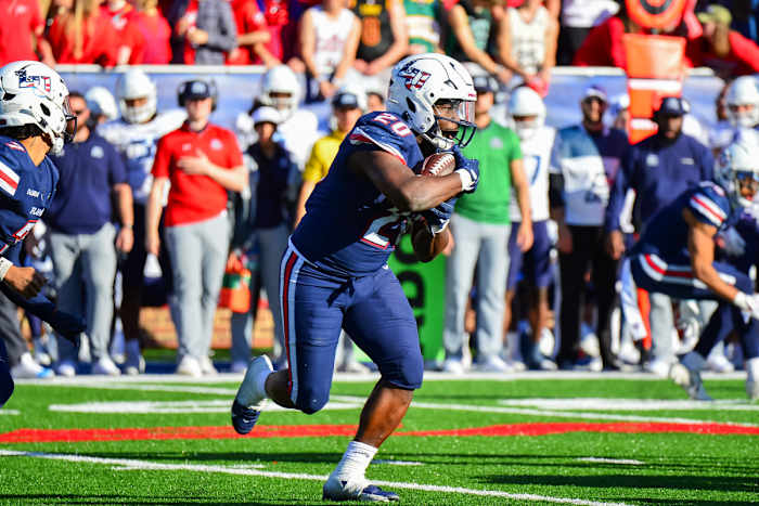 Nov 11, 2023; Lynchburg, Virginia, USA; Liberty Flames running back Quinton Cooley (20) runs the ball in the third quarter at Williams Stadium. Mandatory Credit: Brian Bishop-USA TODAY Sports