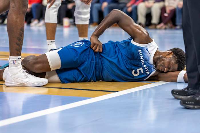 Nov 28, 2023; Minneapolis, Minnesota, USA; Minnesota Timberwolves guard Anthony Edwards (5) reacts after landing on the floor against the Oklahoma City Thunder in the second half at Target Center.