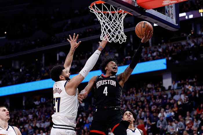 Rockets guard Jalen Green drives to the net against Denver Nuggets guard Jamal Murray (27) in the second quarter at Ball Arena.