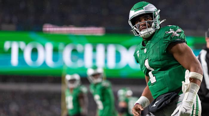 Eagles quarterback Jalen Hurts looks on after scoring a touchdown in a game.