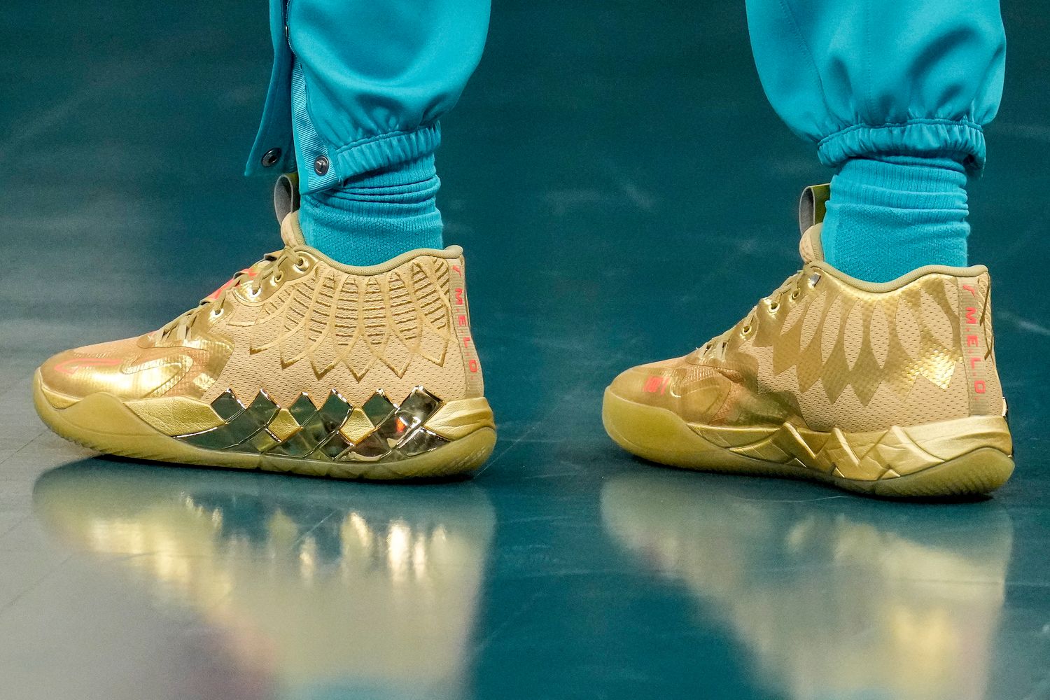 Charlotte Hornets guard LaMelo Ball's gold PUMA sneakers.