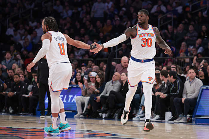 Nov 30, 2023; New York, New York, USA; New York Knicks forward Julius Randle (30) slaps hands with guard Jalen Brunson (11) after a basket during the second half against the Detroit Pistons at Madison Square Garden.