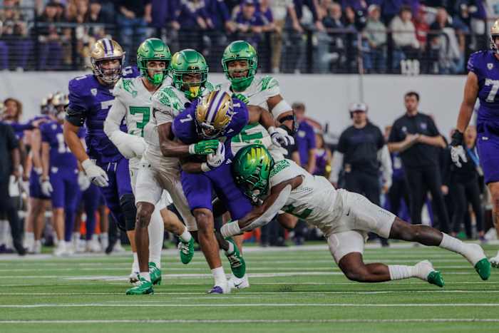 Oregon Ducks linebacker Jeffrey Bassa tackles Dillon Johnson during the Pac-12 championship.