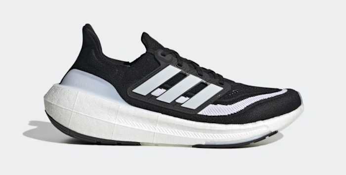 Side view of a black and white adidas running shoe.