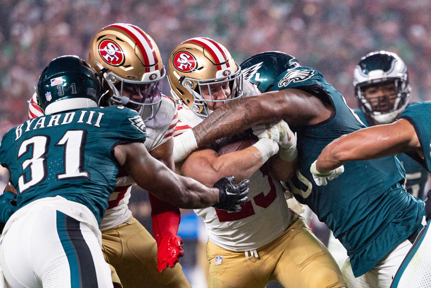 Philadelphia Eagles defensive tackle Jalen Carter (98) tackles San Francisco 49ers running back Christian McCaffrey (23) during the second quarter at Lincoln Financial Field.