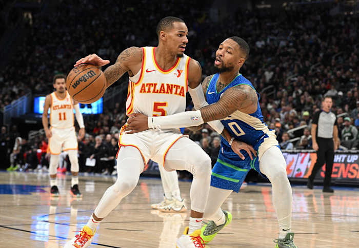 Atlanta Hawks guard Dejounte Murray (5) drives to the basket against Milwaukee Bucks guard Damian Lillard (0)