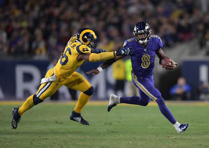 Nov 25, 2019; Los Angeles, CA, USA; Baltimore Ravens quarterback Lamar Jackson (8) is pursued by Los Angeles Rams defensive end Dante Fowler (56) in the third quarter at Los Angeles Memorial Coliseum. The Ravens defeated the Rams 45-6.