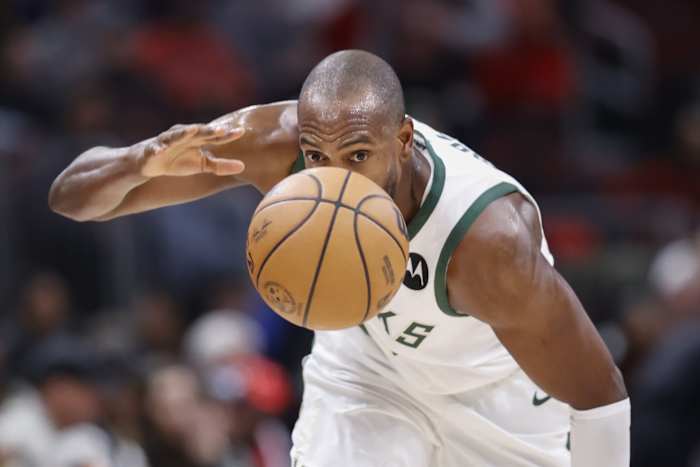 Milwaukee Bucks forward Khris Middleton (22) goes after the ball
