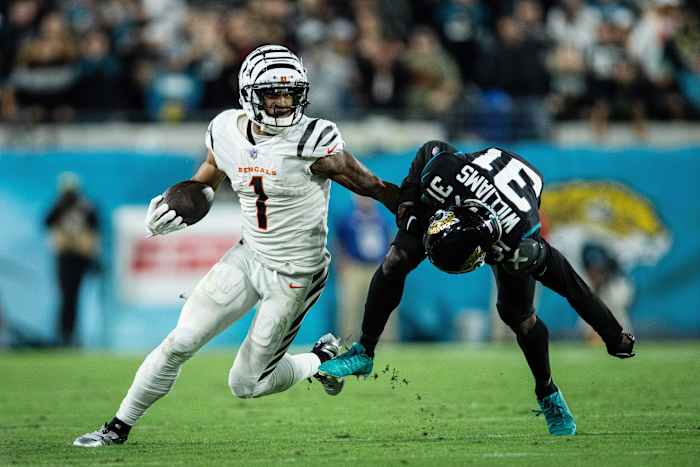 Dec 4, 2023; Jacksonville, Florida, USA; Cincinnati Bengals wide receiver Ja'Marr Chase (1) runs the ball against Jacksonville Jaguars cornerback Darious Williams (31) in extra time at EverBank Stadium. Mandatory Credit: Jeremy Reper-USA TODAY Sports