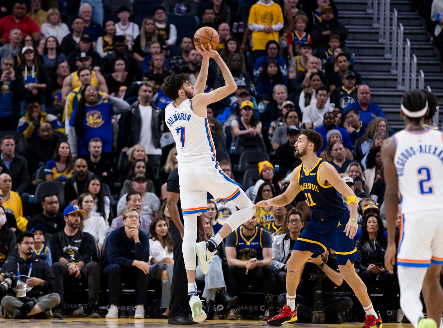 Thunder's Chet Holmgren shoots over Warriors' Klay Thompson. 