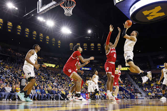Michigan Wolverines forward Olivier Nkamhoua (13) shoots against Indiana Hoosiers forward Anthony Walker (4).