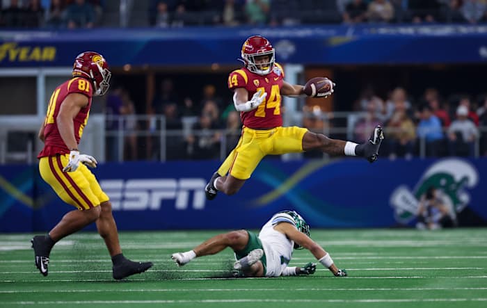 USC Trojans wide receiver Raleek Brown hurdles a Tulane defender.