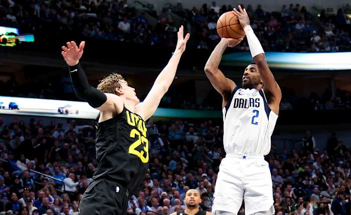 Mavs' Kyrie Irving shoots a jumpshot over Jazz's Lauri Markkanen.