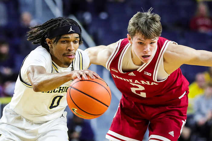 Michigan guard Dug McDaniel dribbles against Indiana guard Gabe Cupps during the first half at Crisler Center in Ann Arbor on Tuesday, Dec. 5, 2023.