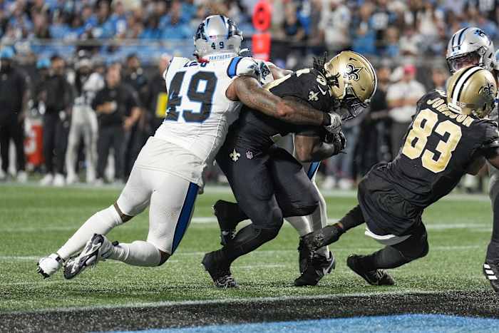 Sep 18, 2023; Carolina Panthers linebacker Frankie Luvu (49) tries to stop New Orleans Saints running back Tony Jones Jr. (34) from crossing the goal line. Mandatory Credit: Jim Dedmon-USA TODAY Sports