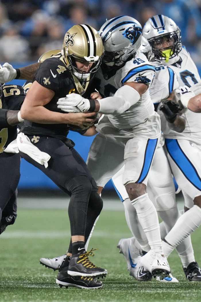 New Orleans Saints quarterback Derek Carr (4) is sacked by Carolina Panthers linebacker Frankie Luvu (49). Mandatory Credit: Jim Dedmon-USA TODAY